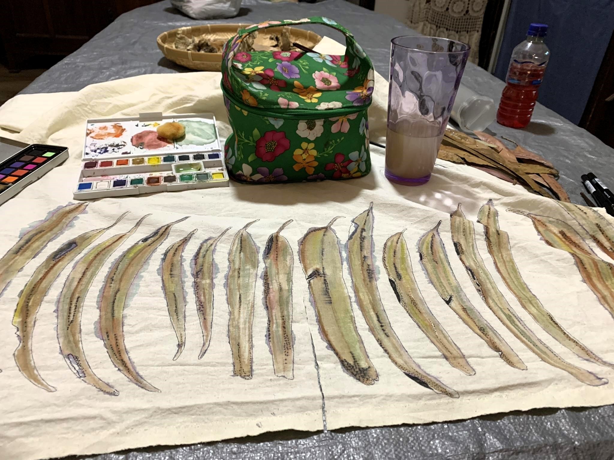 shroud making - painting hand-dyed calico where every leaf represents a year of artist's life so far