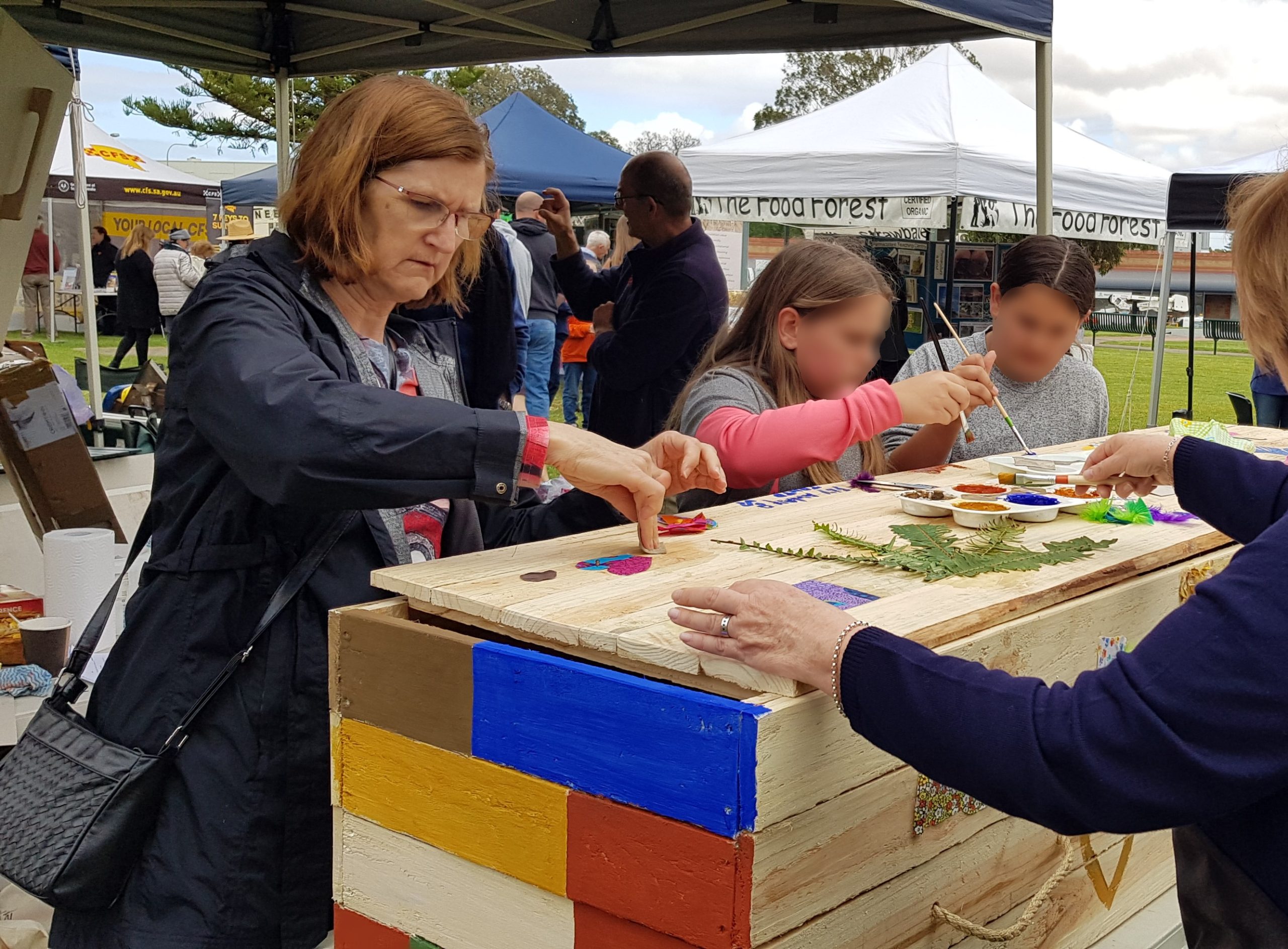 Decorating the eco coffin during the Eco Coffin Project launch at the Gawler Sustainable Living Festival 2019