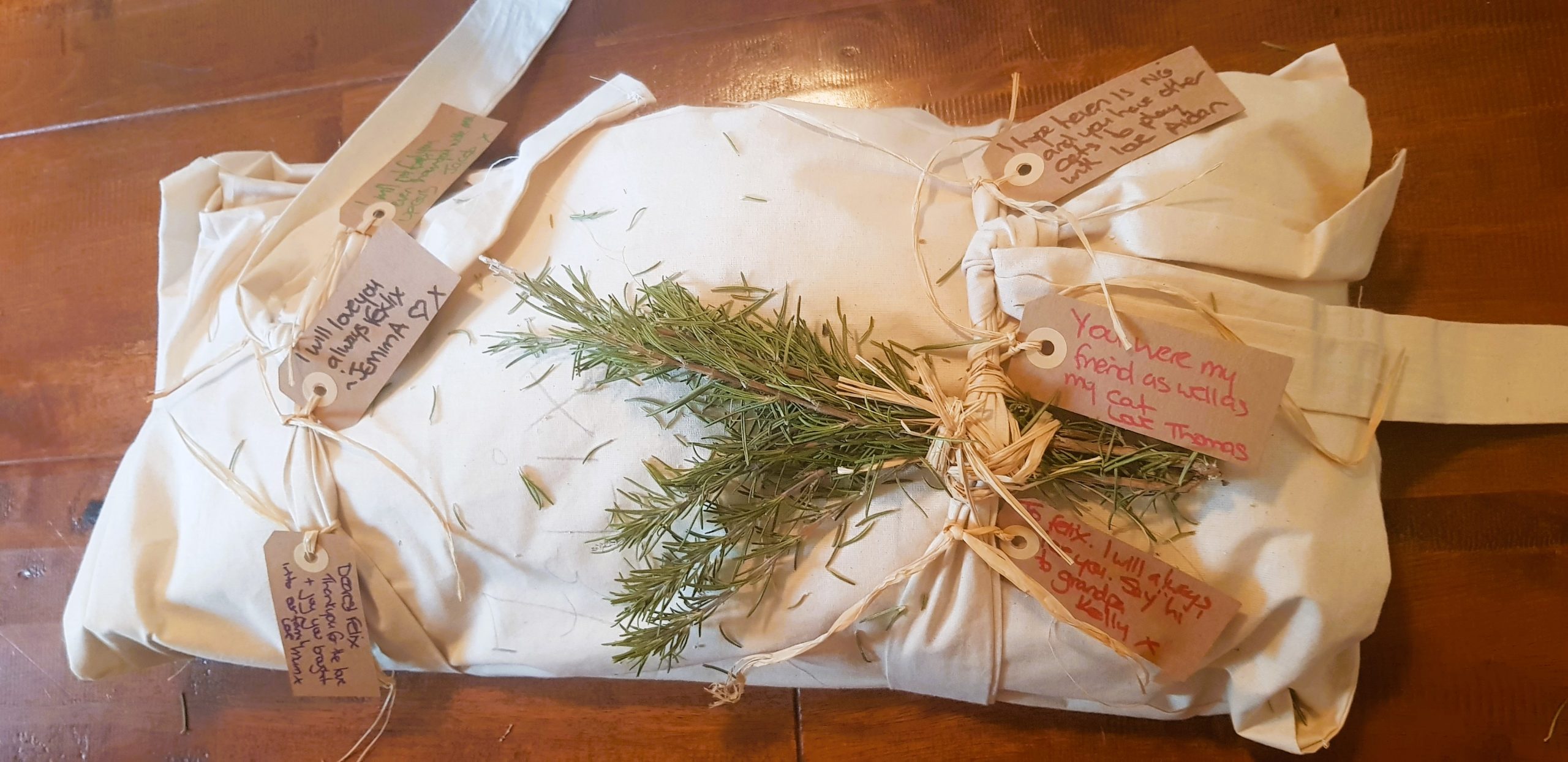 Pet shroud made from calico with brown paper tags with love notes